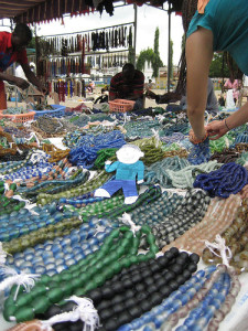Thousands of recycled glass bead strands are arranged by color on market stalls.  Kate Yaeger Rotramel/ Flickr.